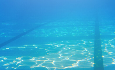 Empty swimming pool, dark lanes marks visible floor, underwater photo