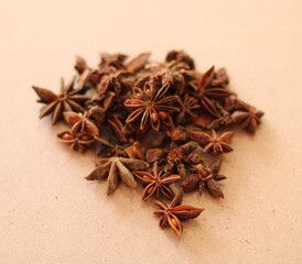 Star anise star anise whole, a handful of star anise on a wooden surface