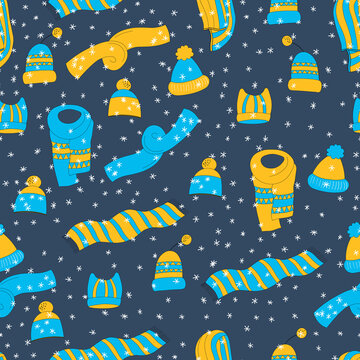 Winter seamless pattern with winter accessories: hats and scarves on blue background. Cute vector winter warm knitted clothes in cartoon style. Christmas vector illustration. Holiday design