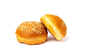 Two hamburger buns with sesame seeds isolated on a white