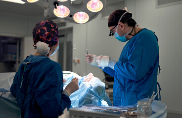 surgeon performs rhinoplasty in the operating room