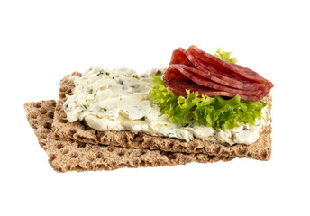 Variety of mini sandwiches with cream cheese, vegetables and salami.