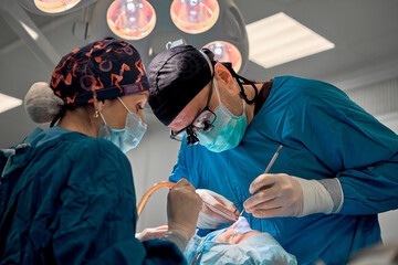 surgeon performs rhinoplasty in the operating room