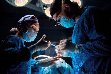 surgeon performs rhinoplasty in the operating room