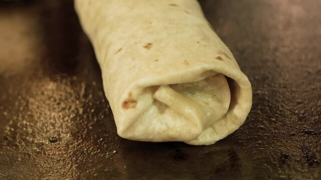 cooking traditional mexican burrito on the grill