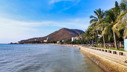 View of Front Beach. Coastline of Vung Tau. Sea, palm trees and hill. Vietnam. South-East Asia	
