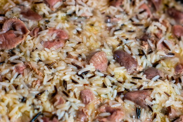 Cooked wild rice pilaf with chicken hearts and stomachs macro close up shot