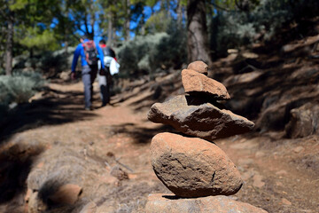 Gran Canaria, Spain -March 23, 2020: Hikers climbing a path where you can see a mark of stones