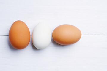 chicken eggs isolated on white wooden background. Clipping path.