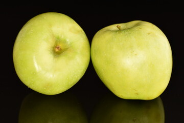 Two natural green apples by Renet Simirenko, close-up, isolated on black.