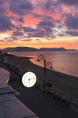 Public clock in Lyme Regis, Dorset at sunrise