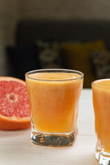 Fresh grapefruit on a white wooden table
