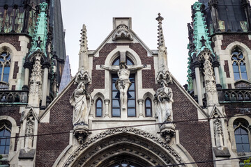Fototapeta na wymiar closeup facade with crucifix scene sculptures on catholic cathedral church in Lviv