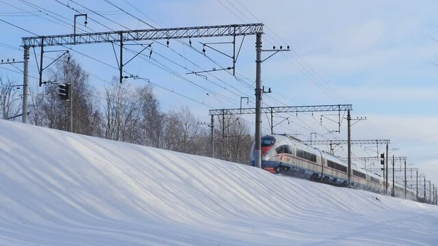 St. Petersburg, Russia, January  25, 2020 Russian Railways high-speed train peregrine, winter white landscape, low angle of view