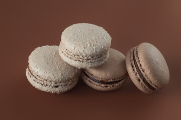 chocolate macaroons on brown background. Close-up, horizontal photo. Traditional French dessert.