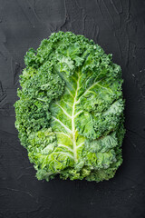 Green kale salad leaf, on black background, top view flat lay