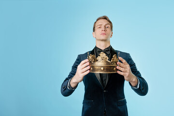 Be a king, crown or reward the best. A man with a crown in his hands, the concept of transferring...