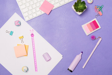  Summer bright vivd Flat lay workspace. Mess of Stationary and keyboard on bright violet purple background, top view. Girly work desktop. School concept. 