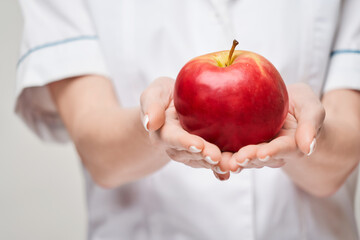 nutritionist doctor healthy lifestyle concept - holding organic red apple