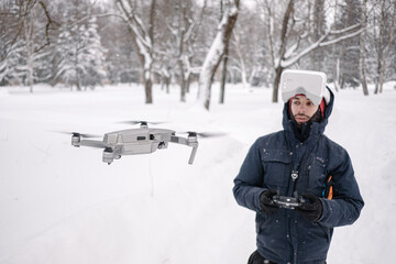 Man in Virtual reality glasses and controller controlling a drone. Drone flying. Modern technology