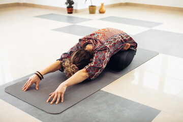 Fit young woman practice yoga. Fitness female instructor doing yoga meditation indoors.
