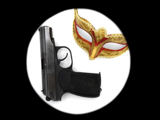 Gun, pistol, traditional golden carnival Venetian mask with red ornament. Preparation for the Brazilian Festival and Mardi Gras, fat Tuesday. The concept of anonymous crime.