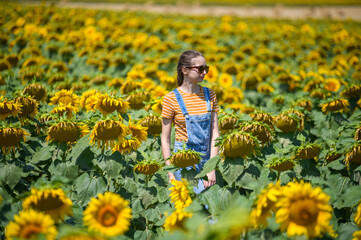 Girl in the middle of field with sunflowers