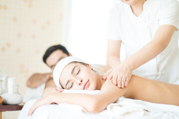 Fototapeta na wymiar Young woman relaxing with hand spa massage at beauty spa salon