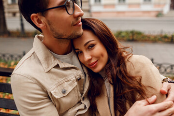 Amazing european couple posing together in cold day. Wearing stylish trench.