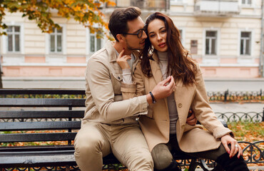 Stylish couple in love posing outdoor. Autumn fashion trends.