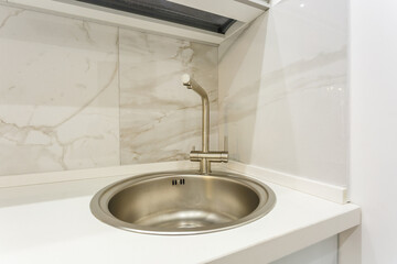 Water tap sink with faucet in expensive kitchen