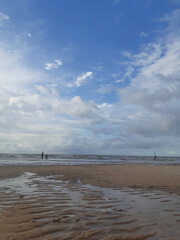 people walking on the beach
