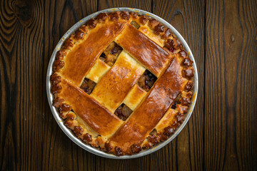 apple pie on a brown wooden table
