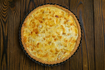 A female baker prepares a cheesecake
