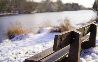 River banks are relaxing place, where one can watch the water and animals. Bench at the bank of the river, during winter times. 