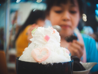 Korean shaved ice dessert with the child eating it