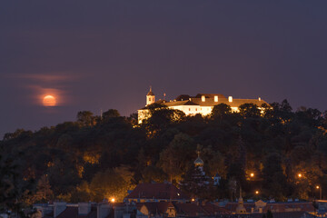 Moonrise over Spilberk castle on a cloudy night. Brno, South Moravia, Czech republic, Europe.