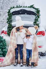 two small children in the winter forest