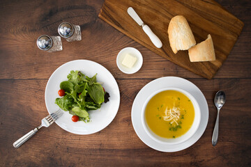 Chicken Noodle Soup and Salad on a Wooden Table