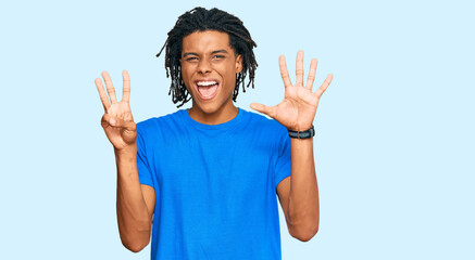 Young african american man wearing casual clothes showing and pointing up with fingers number eight while smiling confident and happy.