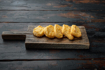 Chicken nuggets on old dark wooden table