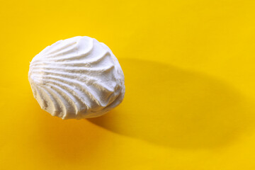  Sweet Zefir at Yellow Background . Soft confectionery made by whipping fruit with sugar and egg whites