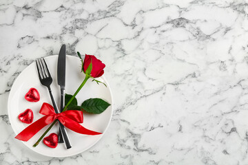 Beautiful table setting on white marble background, top view with space for text. Valentine's Day dinner