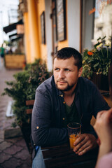 Portrait of a guy outdoors. Summer walk around the city.