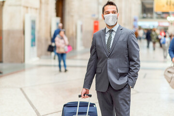 Man walking with trolley at the station, coronavirus covid concept