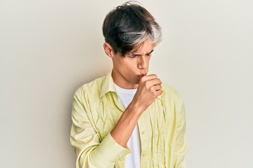 Young hispanic man wearing casual clothes feeling unwell and coughing as symptom for cold or...