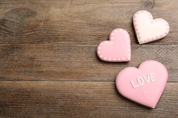Obraz premium Heart shaped cookies on wooden table, flat lay with space for text. Valentine's day treat