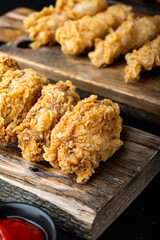 Korean barbeque fried chicken on black wooden table