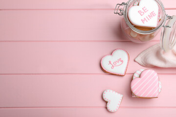 Valentine's day cookies on pink table, flat lay. Space for text