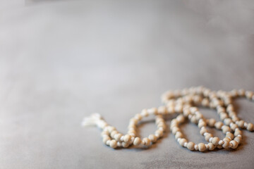 Top view white rosary beads isolated on the grey background